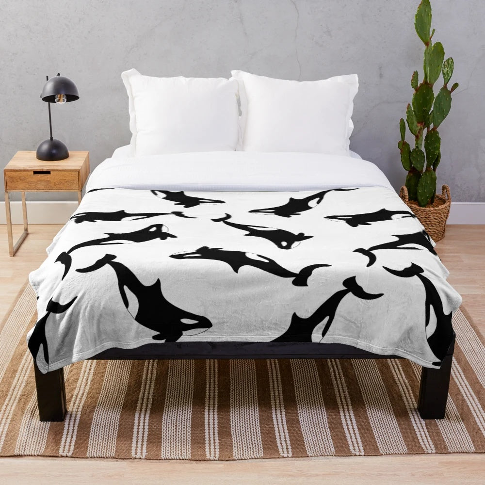 Soft and snuggly orca plush blanket featuring a black and white killer whale design