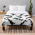 Soft and snuggly orca plush blanket featuring a black and white killer whale design