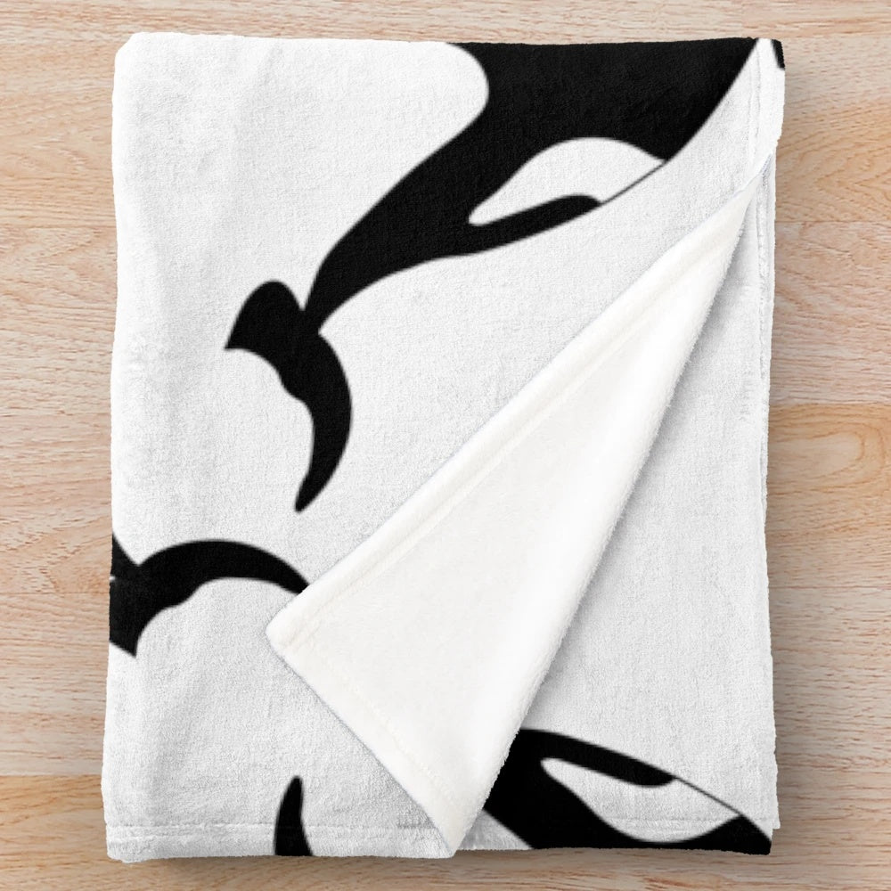 Soft and snuggly orca plush blanket featuring a black and white killer whale design