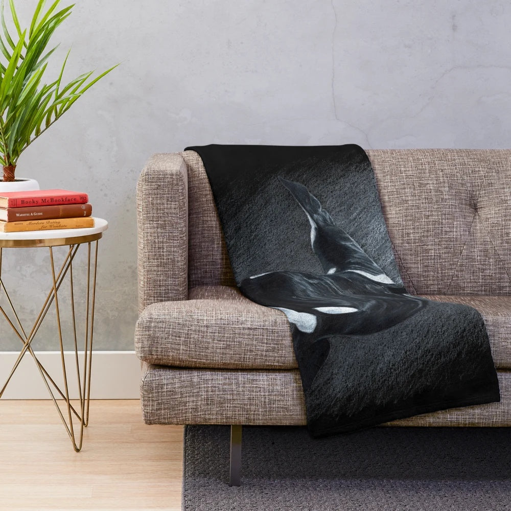Soft and cuddly orca plush blanket featuring a black and white animal print design