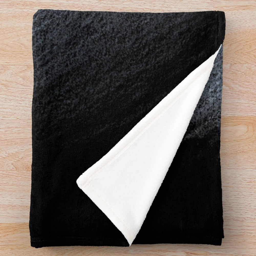 Soft and cuddly orca plush blanket featuring a black and white animal print design