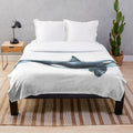 Orca plush blanket featuring a black and white killer whale design