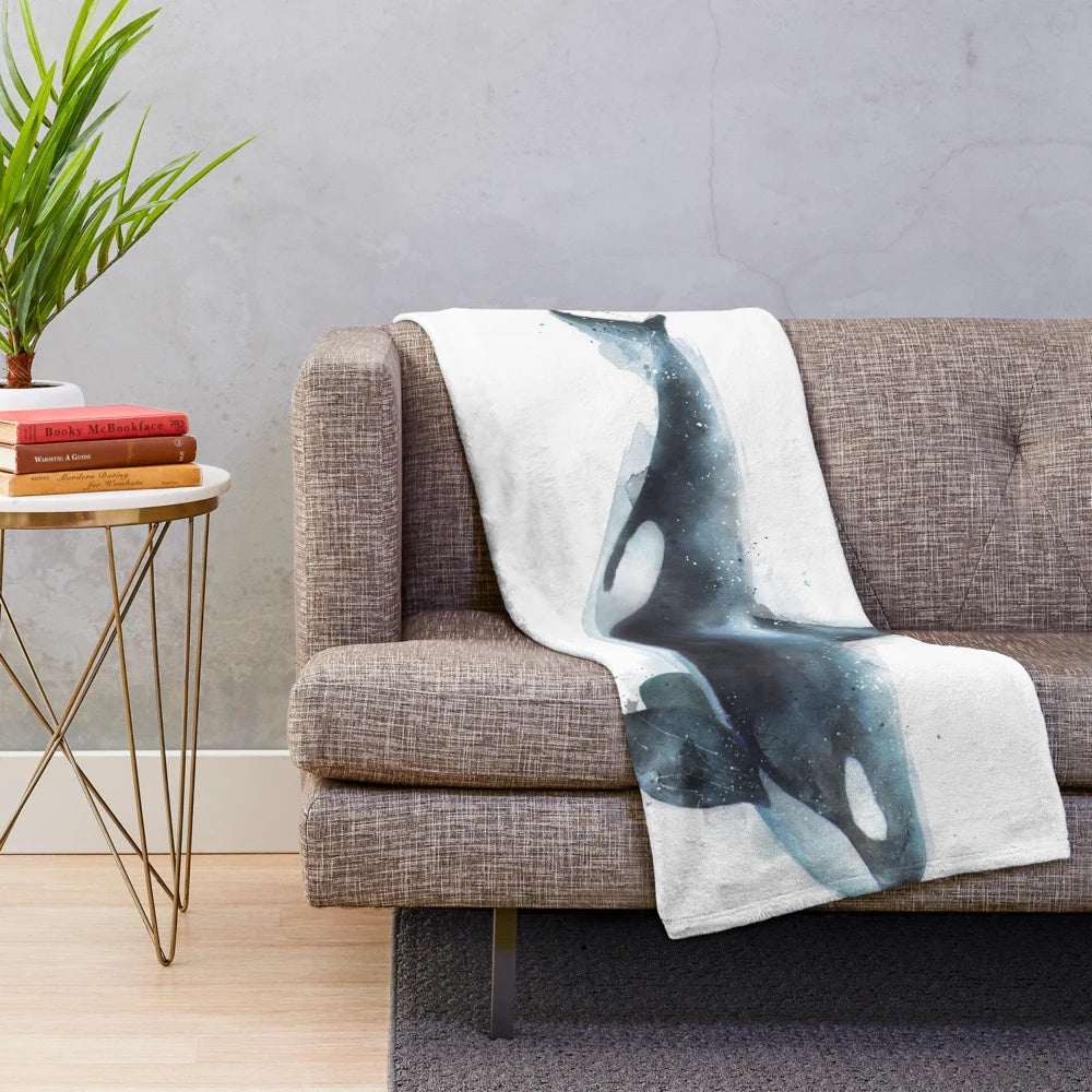 Orca plush blanket featuring a black and white killer whale design