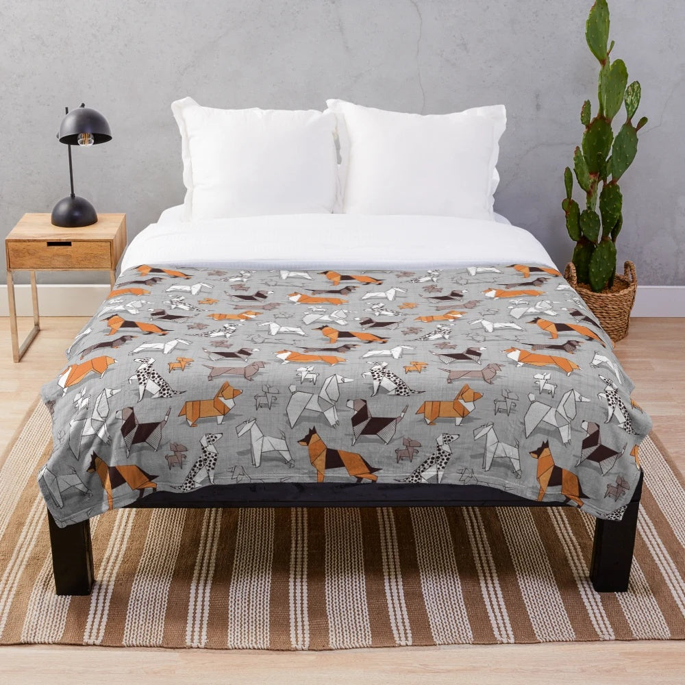 Soft plush blanket featuring an origami-style dog illustration on a grey linen textured background