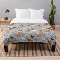 Soft plush blanket featuring an origami-style dog illustration on a grey linen textured background