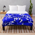 Otomi-inspired dark blue plush blanket with traditional Mexican pattern