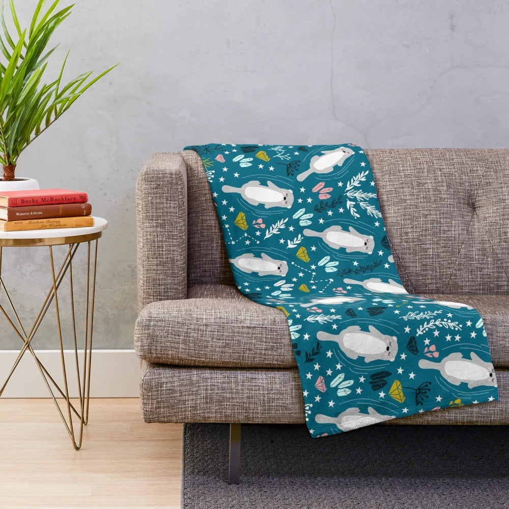 Soft, cuddly otter-patterned plush blanket