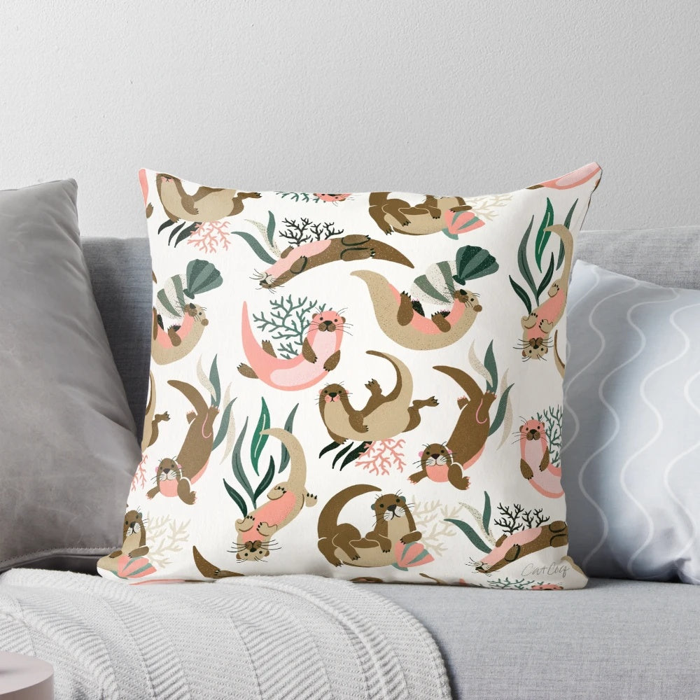 White pillow with a print of a cute sea otter or river otter.