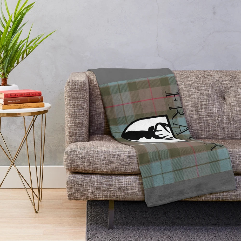 Outlander-themed plush blanket featuring the Clan Fraser tartan and imagery from the popular book and TV series
