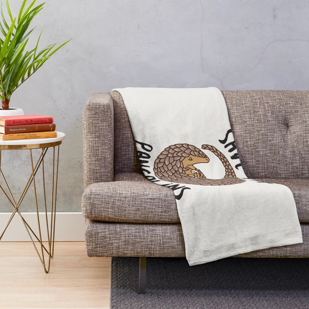 Curled up pangolin illustration on a plush blanket