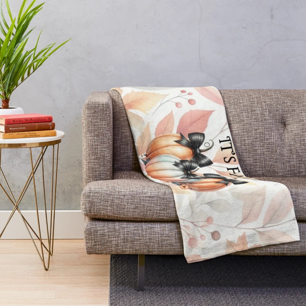 Pastel pumpkin plush blanket with black bow detail
