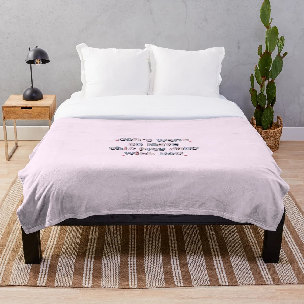 Plush blanket with pastel colors, text, and typography design