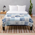 Patchwork blanket with lake, cabin, and water sports motifs