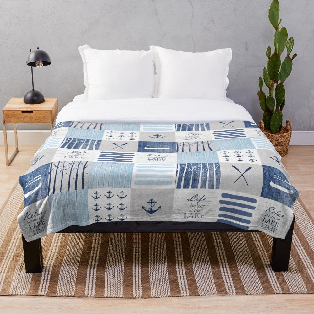 Patchwork blanket with lake, cabin, and water sports motifs