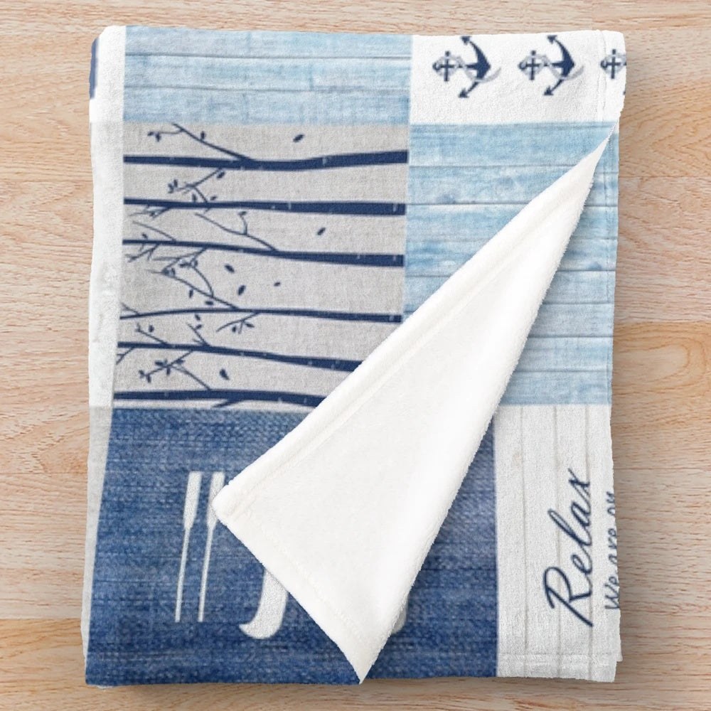 Patchwork blanket with lake, cabin, and water sports motifs