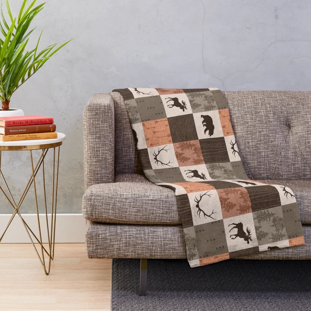Patchwork blanket with rustic woodland and nature-inspired design
