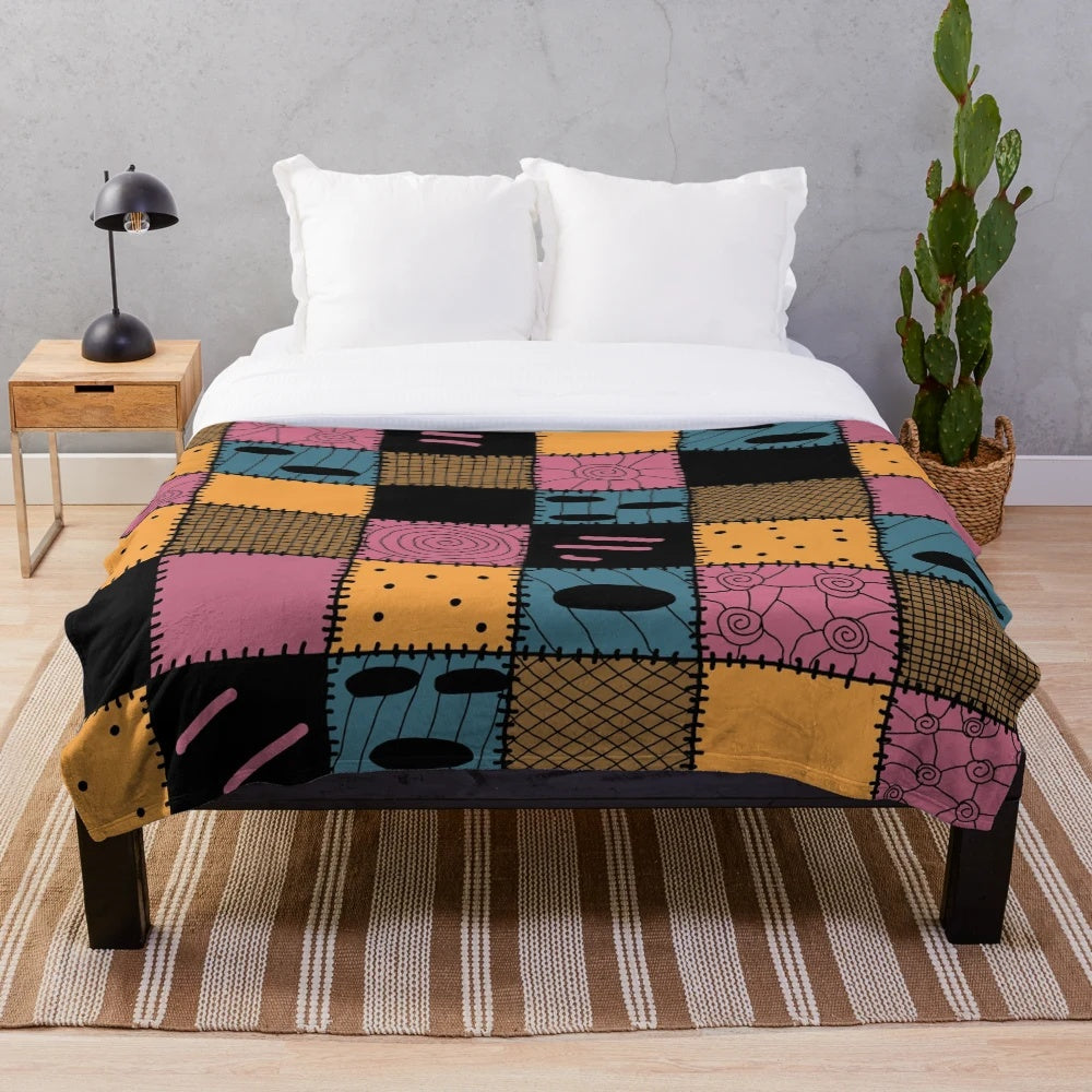 Cozy patchwork plush blanket with a spooky Nightmare Sally inspired pattern