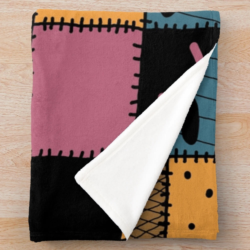 Cozy patchwork plush blanket with a spooky Nightmare Sally inspired pattern