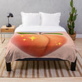 Peach plush blanket with a playful peach emoji design