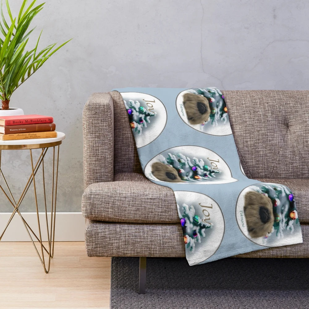 Pekingese dog cuddled in a soft, plush holiday blanket