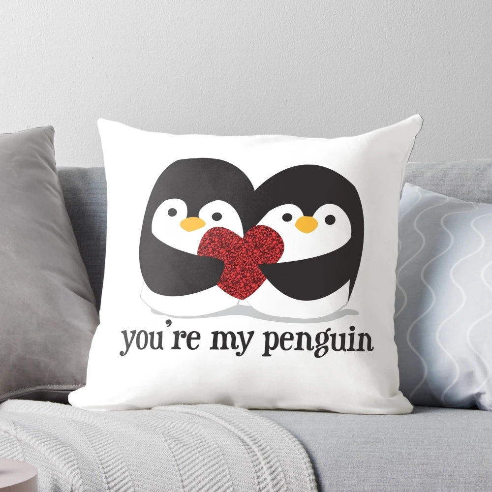 A cuddly black and white penguin pillow with a red heart, showcasing a romantic love quote