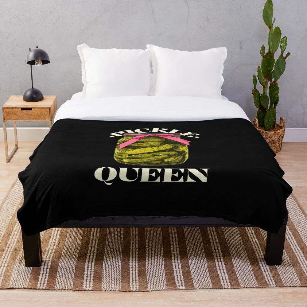 A cozy plush blanket featuring a playful pickle design, perfect for pickle lovers and pickleball fans.