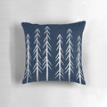 A navy blue and grey pillow with a sketch-style pine tree design and white arrows