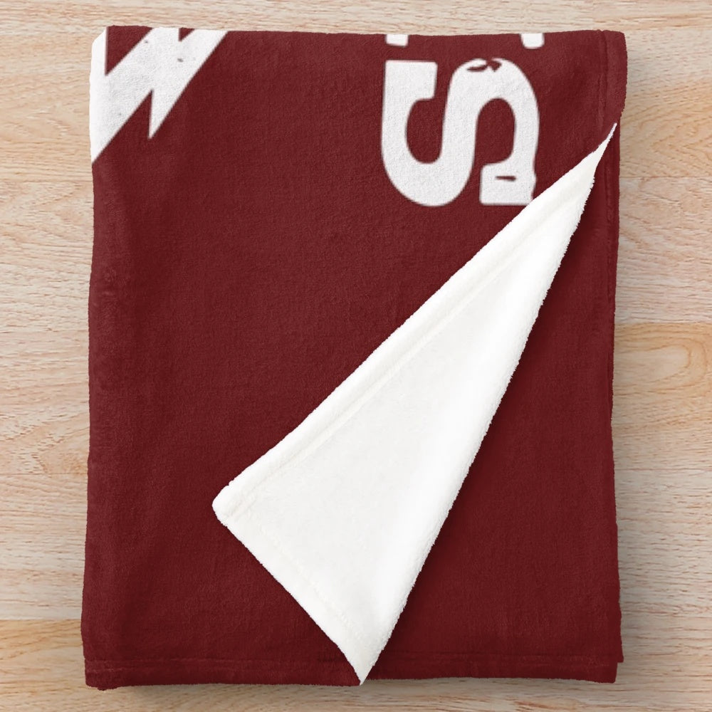 A plush blanket featuring a hand holding a ping pong paddle