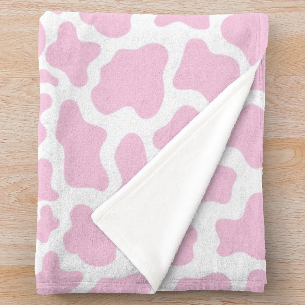 Soft and plush pink cow print blanket for home decor
