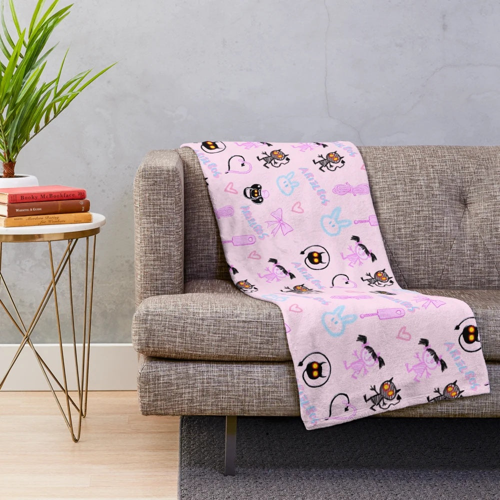Soft and snuggly pink plush blanket with kawaii demon design