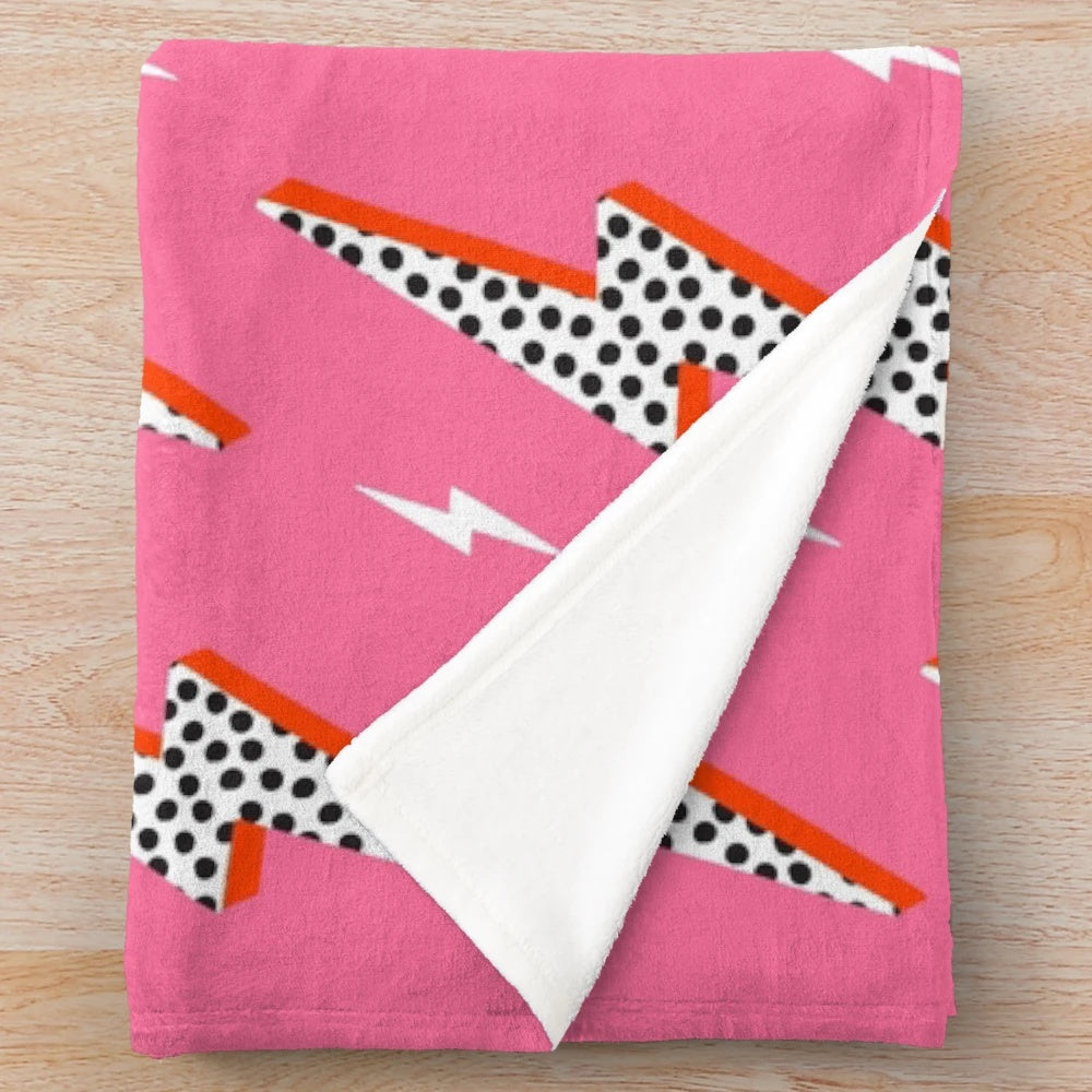 Pink lightning bolt plush blanket with a preppy design