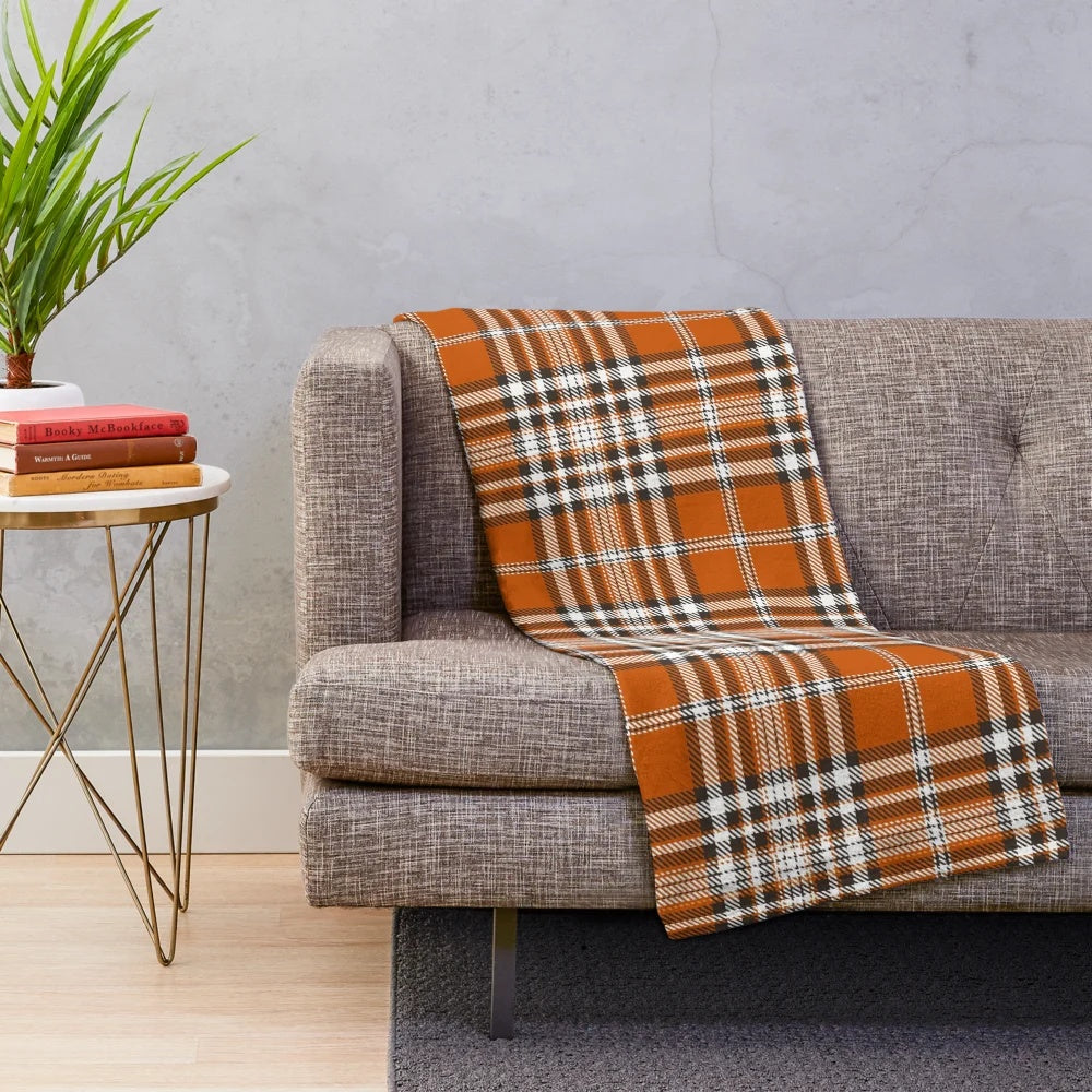 Autumn-inspired plaid plush blanket with an orange and red pattern