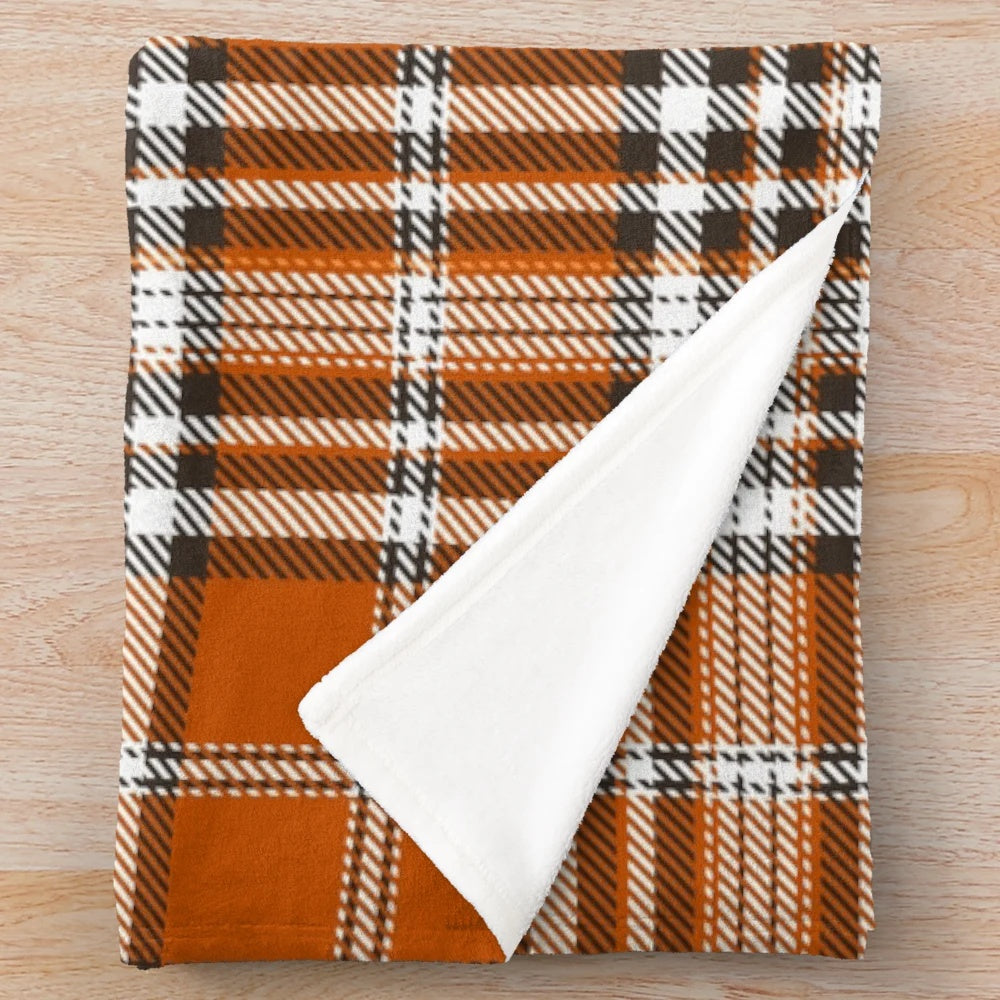 Autumn-inspired plaid plush blanket with an orange and red pattern
