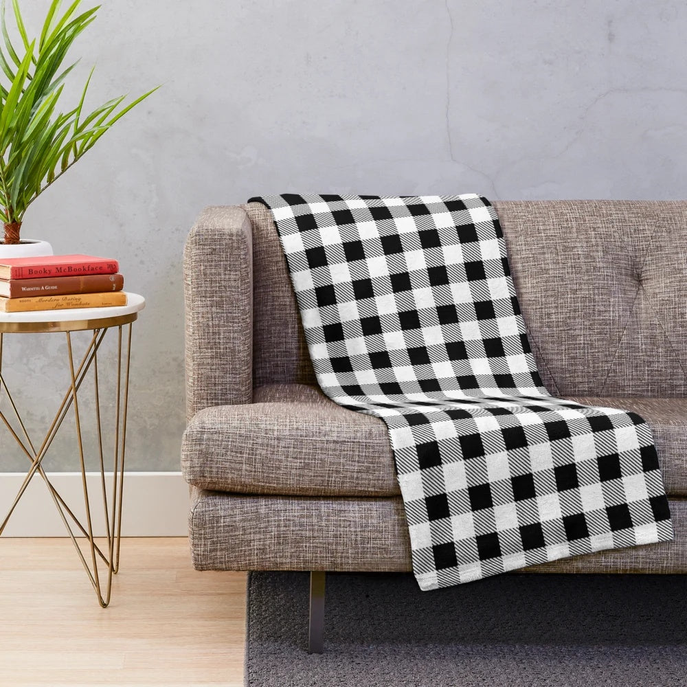 Plaid plush blanket in black and white buffalo check pattern