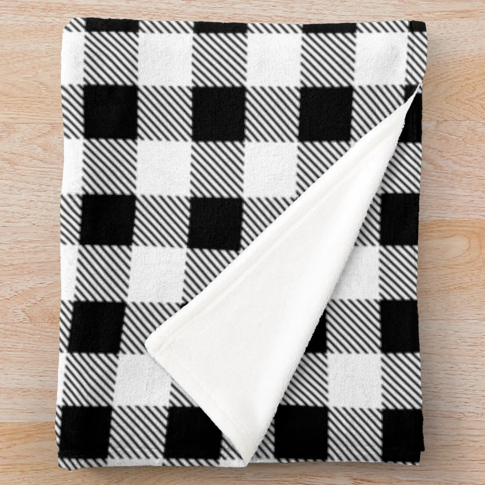 Plaid plush blanket in black and white buffalo check pattern