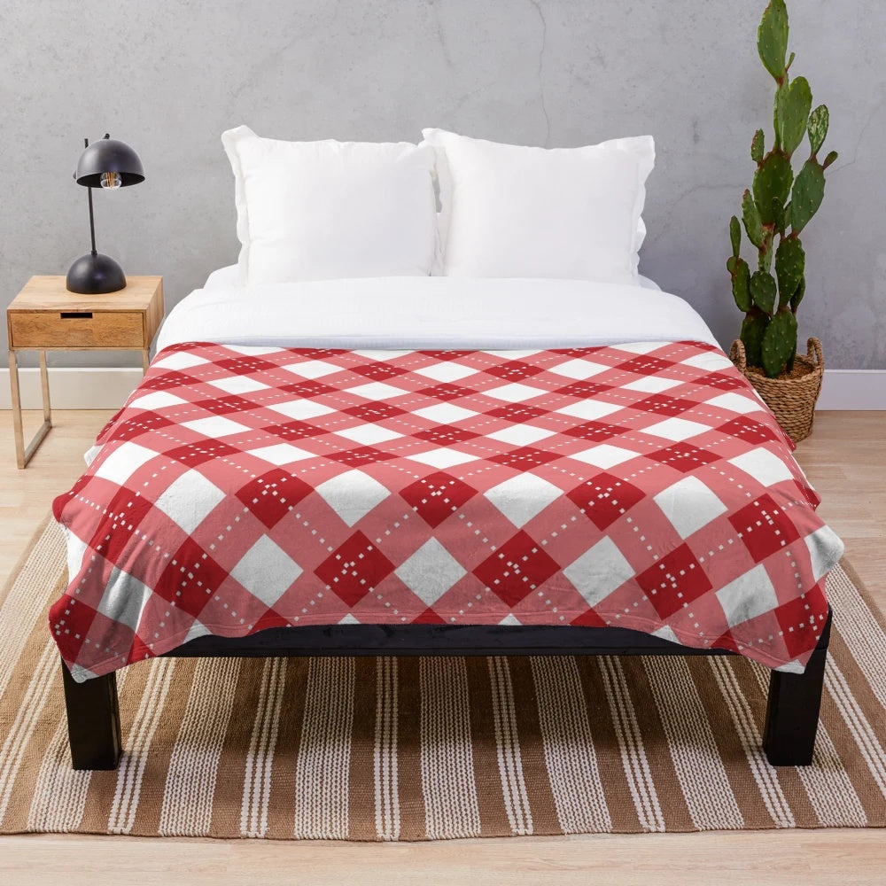 Cozy plaid plush blanket in red and white with a classic Scottish tartan pattern