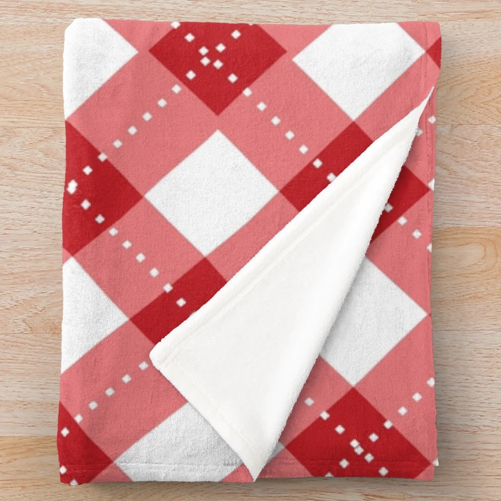 Cozy plaid plush blanket in red and white with a classic Scottish tartan pattern