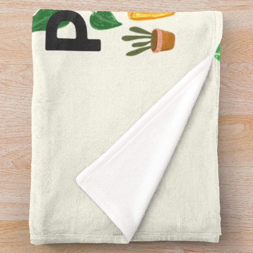 Plush blanket with a home is where my plants are design, featuring various houseplants and botanical elements