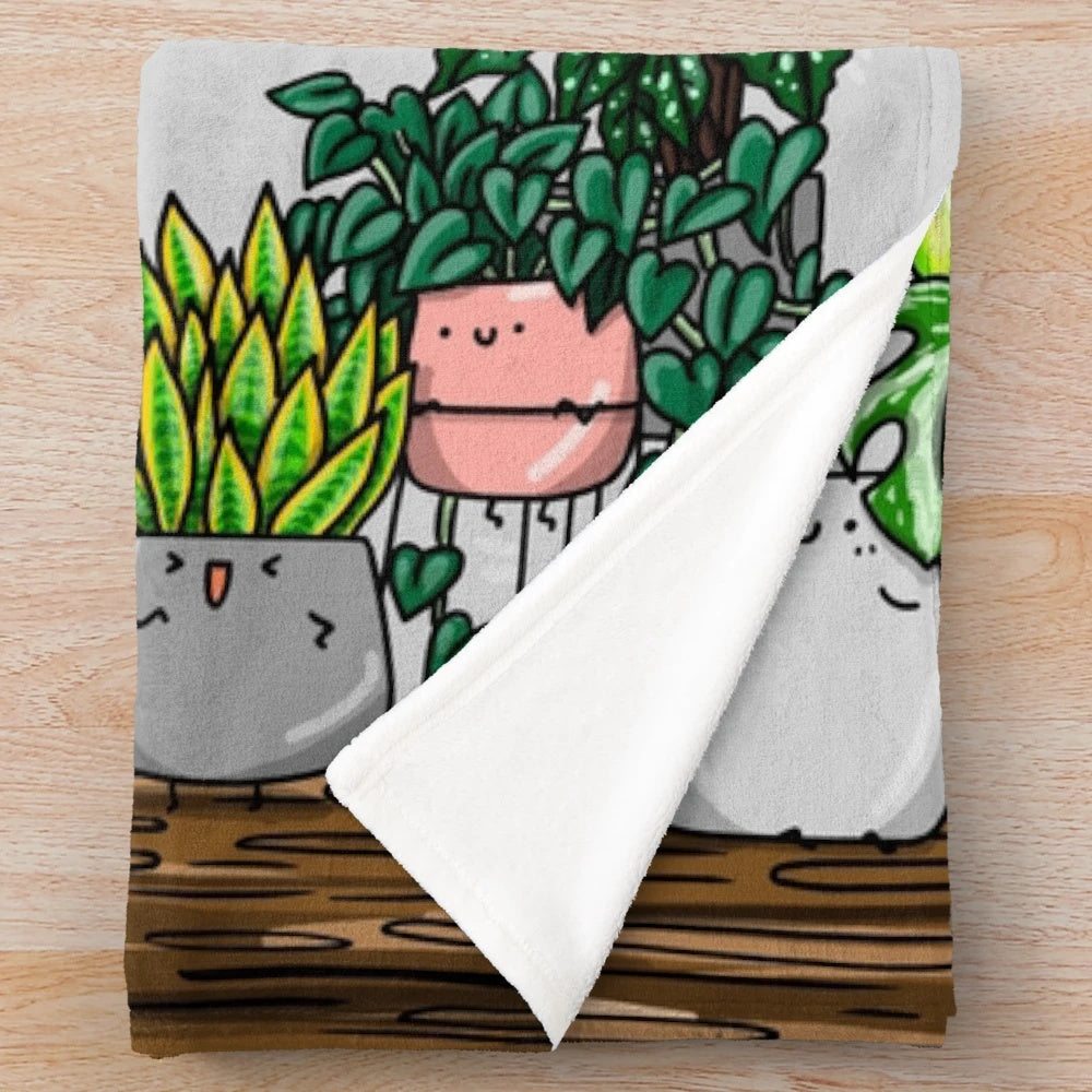 Plush plant-themed blanket with illustrations of houseplants