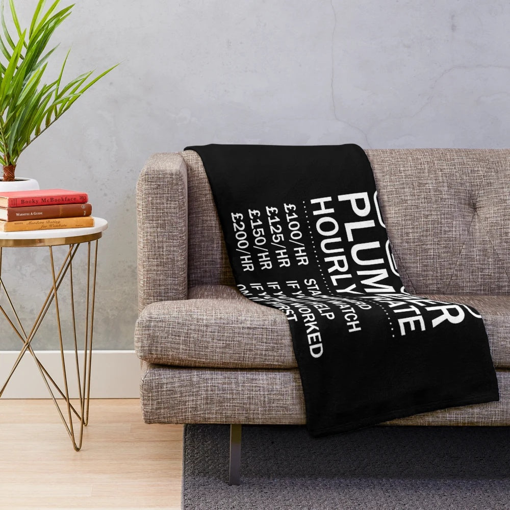Plumber-themed plush blanket with various plumbing-related graphics and designs