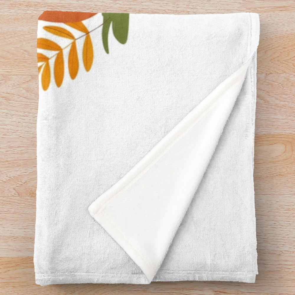 Soft, plush autumn-themed blanket with colorful leaves