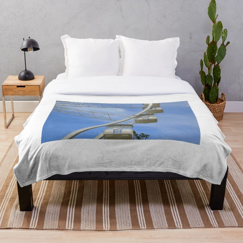 Plush blanket featuring a carnival scene with ferris wheel and rides