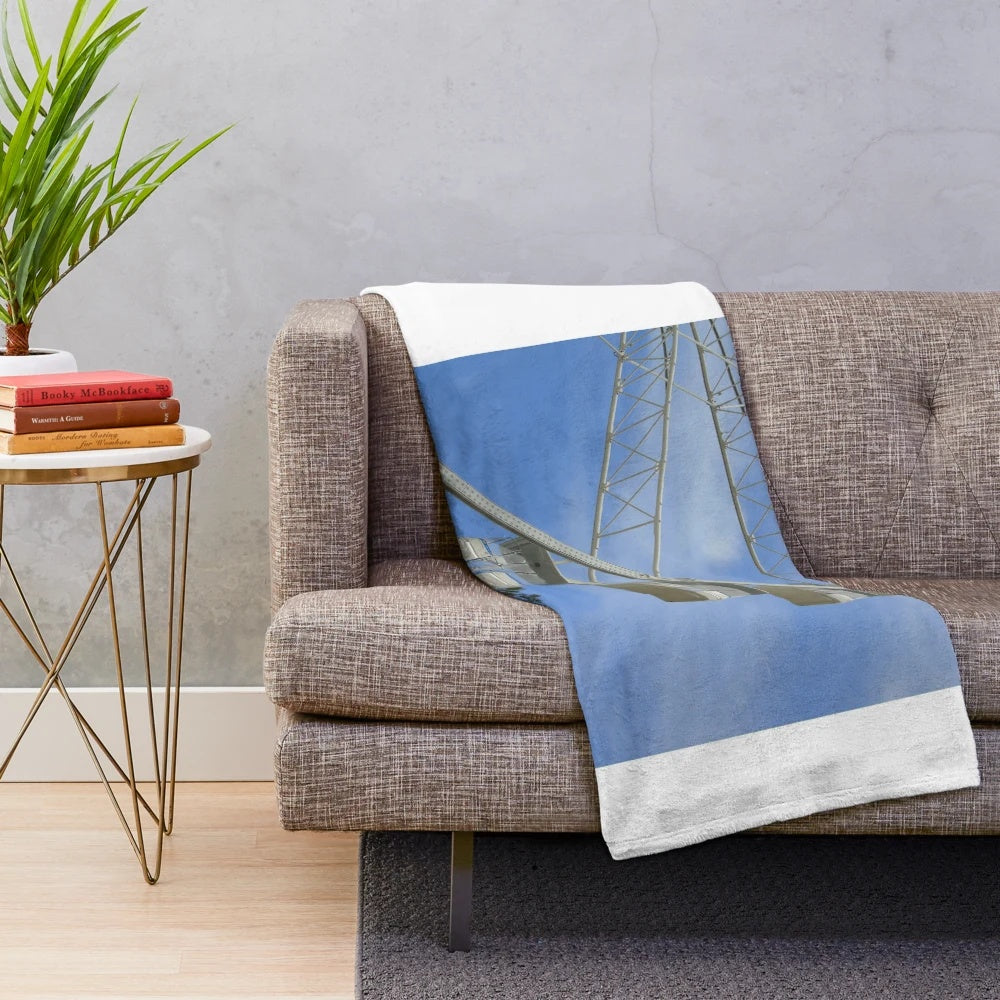 Plush blanket featuring a carnival scene with ferris wheel and rides