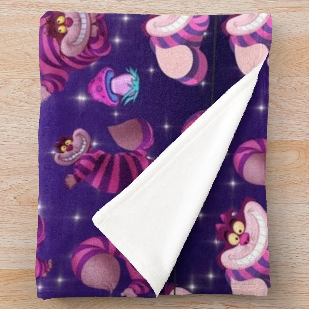 Plush blanket with a wonderland design featuring a cat and mushrooms
