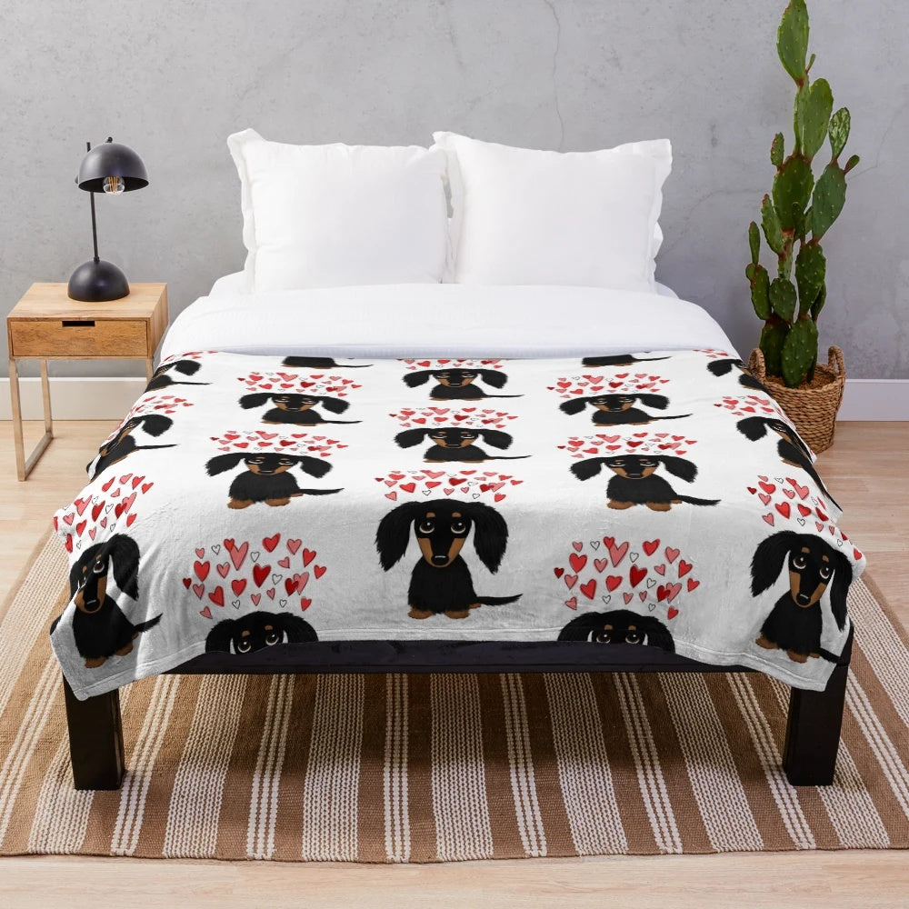 A soft and plush blanket featuring an adorable long-haired dachshund dog in black and tan colors