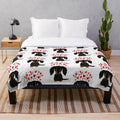 A soft and plush blanket featuring an adorable long-haired dachshund dog in black and tan colors