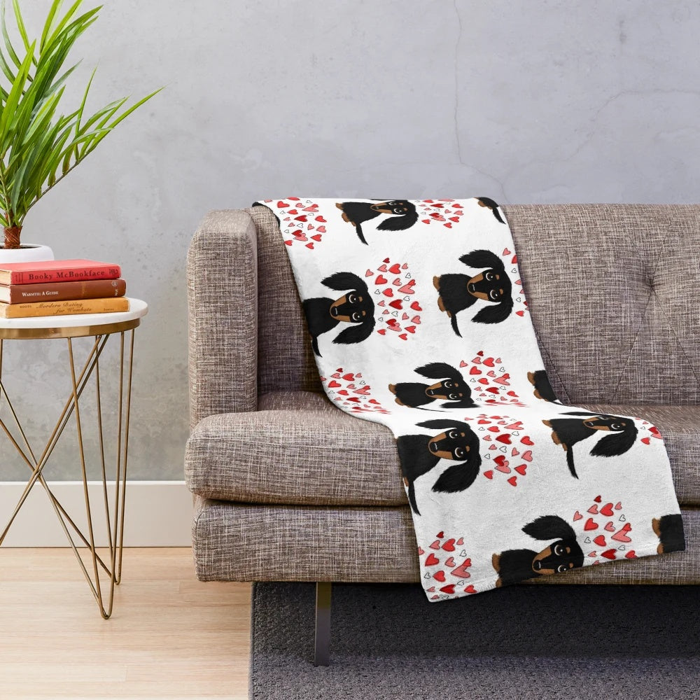 A soft and plush blanket featuring an adorable long-haired dachshund dog in black and tan colors