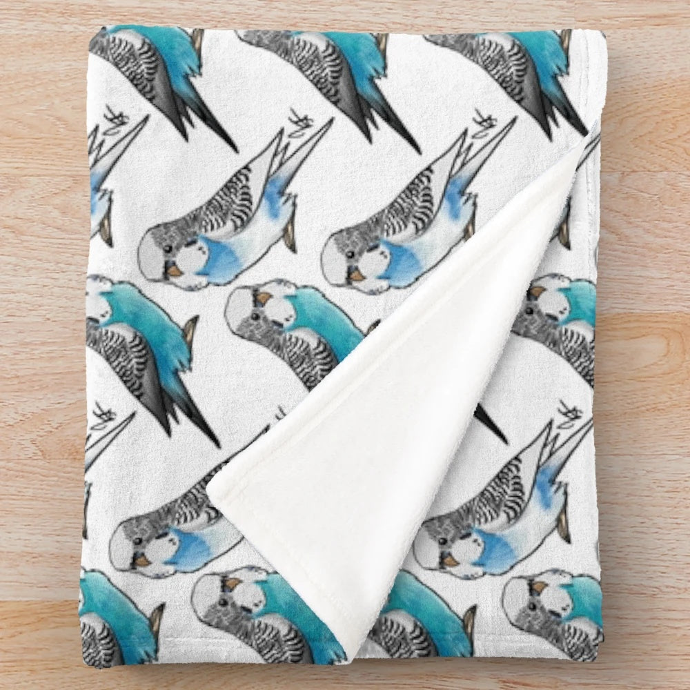 Two adorable blue budgies on a plush blanket