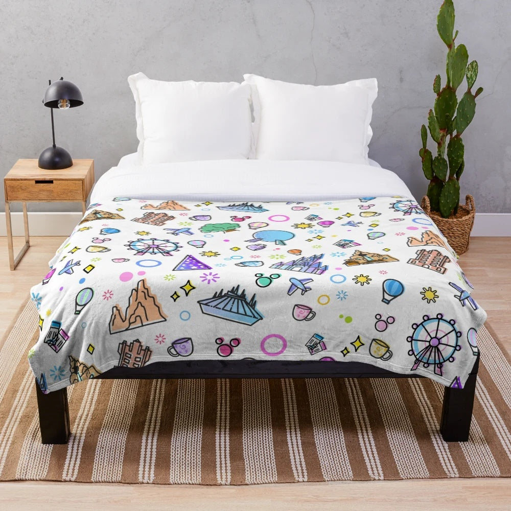 Plush blanket with Disney World theme park icons including Ferris wheel, hot air balloon, and Spaceship Earth.