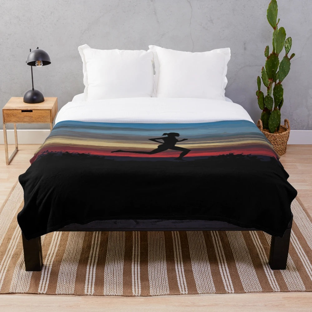 A plush blanket featuring a silhouette of a running girl against a scenic sunset backdrop